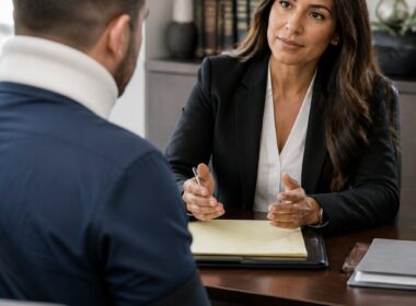 A personal injury attorney meets with a client in a modern law office.